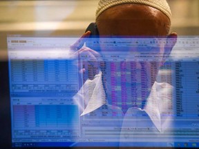 A stockbroker monitors the latest share prices during a trading session at the Pakistan Stock Exchange (PSX) in Karachi on March 9, 2020.