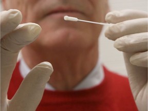 A doctor prepares to take a nasal swab in this file photo. Albertans getting tested for COVID-19 have to receive a nasal swab by a healthcare professional.