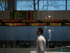 A passerby inside the building that houses the Toronto Stock Exchange on Monday, March 9, 2020.