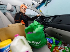 Rahul Kumar poses for a photo in his car filled with groceries on Friday, April 10, 2020. Azin Ghaffari/Postmedia