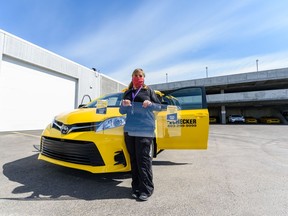 Kim Formella, Checker Cabs co-owner, poses with the plexiglass shield the company is installing in their cabs to protect the drivers from COVID-19 on Monday, April 13, 2020. Azin Ghaffari/Postmedia