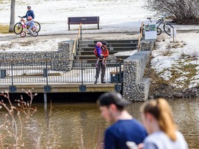 People spend the afternoon in Confederation Park on Friday, April 17, 2020. Azin Ghaffari/Postmedia