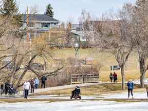People spend the afternoon in Confederation Park on Friday, April 17, 2020. Azin Ghaffari/Postmedia
