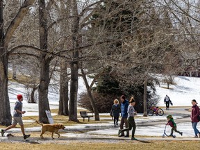 People spend the afternoon in Confederation Park on Friday, April 17, 2020. Azin Ghaffari/Postmedia