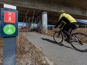 A cyclist moves along the bike path in Riverwalk on Monday, April 27, 2020.