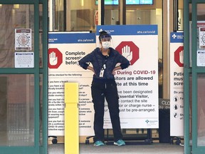 Peter Lougheed Centre hospital staff wait to screen essential visitors who are the only visitors permitted in Alberta hospitals as part of COVID-19 precautions on Tuesday, April 7, 2020.