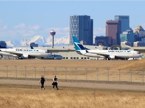 Parked WestJet Boeing 737 planes and the Calgary skyline were the backdrop for a quiet walk during the COVID-19 pandemic on April 21, 2020.