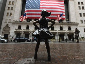 In this file photo The Fearless Girl statue stands in front of the New York Stock Exchange near Wall Street on March 23, 2020 in New York City. The economic crash is certainly significant, but it's not the apocalypse, says columnist.