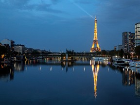 This picture taken on April 12, 2020, shows the Eiffel tower and its reflection on the Seine river, in Paris, on the 27th day of a strict lockdown aimed at curbing the spread of the COVID-19 pandemic, caused by the novel coronavirus. (Photo by Ludovic MARIN / AFP) (Photo by LUDOVIC MARIN/AFP via Getty Images)