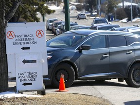 Long line ups continue at the Assessment Centre set up at the Richmond Road Diagnostic and Treatment Centre to get tested for COVID-19 in Calgary on Monday, April 13, 2020. Darren Makowichuk/Postmedia