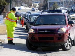 Long line ups continue at the Assessment Centre set up at the Richmond Road Diagnostic and Treatment Centre to get tested for COVID-19 in Calgary on Monday, April 13, 2020. Darren Makowichuk/Postmedia