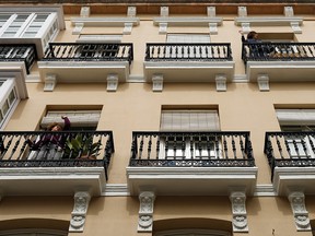 Women exercise on their balconies during a partial lockdown due to the COVID-19 pandemic in Ronda, Spain, on March 18, 2020.