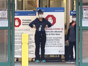 Peter Lougheed Centre hospital staff wait to screen essential visitors who are the only visitors permitted in Alberta hospitals as part of COVID-19 precautions on Tuesday, April 7, 2020.