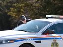 RCMP Officer Justin Buggie (L) speaks with fellow RCMP Officer Cedric Landry after Gabriel Wortman, a suspected shooter, was arrested on April 19, 2020 in Portapique, Nova Scotia, Canada. 