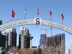 An overhead sign at Stampede Park frames the Calgary skyline on Thursday, April 16, 2020.