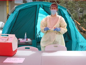 Dr. Amelia Leskiw takes COVID-19 samples at a drive-through location in High River, south of Calgary, on Friday, April 17, 2020.