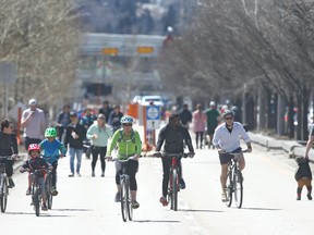 Calgarians take to the blocked off portion of Memorial Drive near 5 St NW in northwest Calgary on Sunday, April 19, 2020. Some were keeping the appropriate safe social distance, but many were walking, biking, running together. Jim Wells/Postmedia