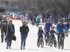 Calgarians take to the blocked off portion of Memorial Drive near 5th Street N.W. on Sunday, April 19, 2020.