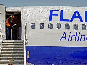 Flair Airlines maintenance manager Darryl Balaban sanitizes an aircraft at Edmonton International Airport on April 6, 2020.