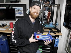 Dustin Milne, Major Event Planner with Alberta Ghostbusters, showcases homemade plastic ear bands he produced with his 3D printer in his home office. The non-profit group that worked on the latest Ghostbuster movie has joined forces for the good to create face shields, masks and other medical supplies for healthcare workers during the COVID-19 pandemic.  Sunday, April 5, 2020. Brendan Miller/Postmedia