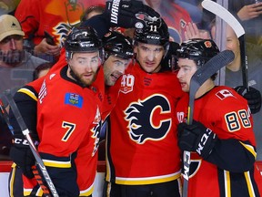 Calgary Flames Mikael Backlund celebrates with teammates after scoring a goal against the Arizona Coyotes during NHL hockey in Calgary on Friday March 6, 2020. Al Charest / Postmedia