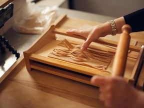 Chef and culinary instructor Ema Costantini uses a chitarra (pasta guitar) to cut strands of pasta made with ingredients she had on hand: spelt flour and egg whites from her freezer.