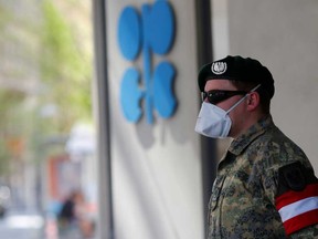 An Austrian army member stands next to the logo of the Organization of the Petroleoum Exporting Countries (OPEC) in front of OPEC's headquarters in Vienna, Austria April 9, 2020.