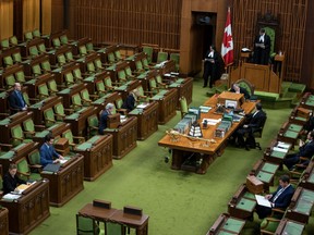 Prime Minister Justin Trudeau, Conservative Leader Andrew Scheer and Members of Parliament wait for proceedings to begin in the House of Commons on Parliament Hill in Ottawa, as Parliament was recalled for the consideration of measures related to the COVID-19 pandemic, on Saturday, April 11, 2020.