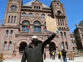 A protester demands the removal of the provincial COVID-19 restrictions outside the Ontario legislature in Toronto on Saturday, April 25, 2020.