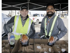 Brad Picklyk and Rukman Sri with Continental Commercial Vehicle Tires pose with homemade lunches, that include sanitization kits, to truck drivers at the Flying J Travel Centre. 
Truck drivers are among the "invisible people" we take for granted, says columnist Chris Nelson.