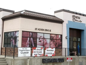 Signs are hung outside Esthetica Salon and Spa in the SE following Premier Jason Kenney's announcement to gradually open Alberta's economy during the COVID-19 pandemic. Thursday, April 30, 2020. Brendan Miller/Postmedia