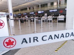 An empty Air Canada check-in counter is seen at Montreal-Trudeau International Airport in Montreal, on Wednesday, April 8, 2020.