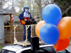 Matt Masters, founder of Curbside Concerts performs on top of his van during a Birthday Party in Calgary on Saturday, May 9, 2020. Darren Makowichuk/Postmedia