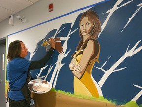 Artist Kalum Teke Dan completes a painting in the main area at the Brenda Strafford Centre in Calgary on Tuesday, July 9, 2019.