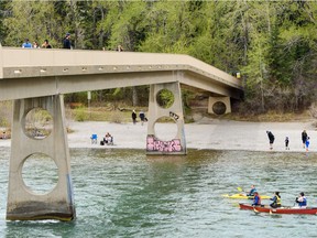 People spend the day outside on a warm spring afternoon by the Bow River on Monday, May 18, 2020.