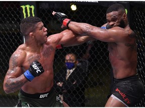 LAS VEGAS, NEVADA - MAY 30: In this handout provided by UFC,  (L-R) Gilbert Burns of Brazil punches Tyron Woodley in their welterweight fight during the UFC Fight Night event at UFC APEX on May 30, 2020 in Las Vegas, Nevada.