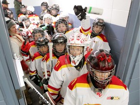 FILE - Members of the Atom 1 South Bow Valley Black team are seen cheering before they hit the ice at the Lake Bonavista arena during the 2019/2020 Esso Minor Hockey Week hosted by Hockey Calgary.
