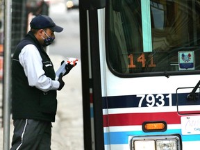 A Calgary Transit bus driver prepares to sanitize his bus in downtown Calgary on Thursday, May 7, 2020. Calgary Transit is facing layoffs with ridership down as much as 90 percent in certain areas due to the COVID-19 pandemic.