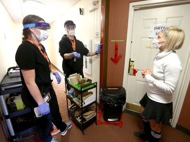Nurses Emma Wissink (L) and Keel Stewart chat with Dr Kerri Treherne (R) at the assisted self isolation hotel in Calgary on Thursday, May 7, 2020. Postmedia has agreed not to reveal the exact location of the hotel. Jim Wells/Postmedia