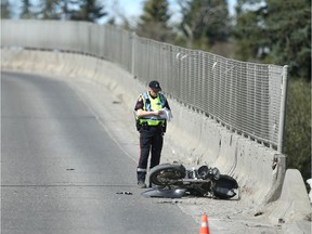 Calgary Police Traffic Unit investigates at a motorcycle accident scene on northbound Macleod Tr near 34 Ave SW in Calgary on Saturday, May 16, 2020. A male was rushed to hospital in life threatening condition. Jim Wells/Postmedia