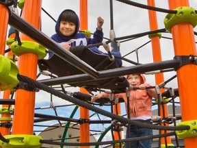 Tejas Singh, left and Lincoln Spragg have fun climbing at the Midtown playground in Airdrie on Saturday, May 23, 2020. Airdrie opened playgrounds on Friday after they were closed for about two months because of the COVID-19 pandemic.