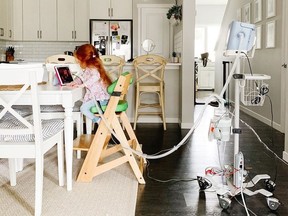 Evanna Irvine, 6, takes part in a Zoom meeting as part of her virtual schooling at the kitchen table of her Calgary home. Irving was born with a rare congenital heart defect and has a terminal diagnosis.