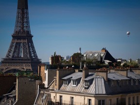 The weather balloon of Airparif, the organization responsible for monitoring the air quality in the Ile de France region, flies next to the Eiffel Tower in Paris, on May 7, 2020, on the 52nd day of a strict lockdown in France. While air pollution has declined in major cities around the world, CO2 emissions have not.