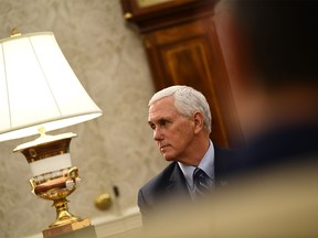 (FILES) In this file photo US Vice President Mike Pence listens as US President Donald Trump speaks during a meeting with Texas Governor Greg Abbott on May 7, 2020, in the Oval office of the White House in Washington, DC.