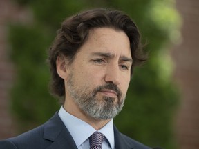 Prime Minister Justin Trudeau is seen as he is asked a question on the military reports on seniors residences during a news conference outside Rideau Cottage in Ottawa, Wednesday May 27, 2020.