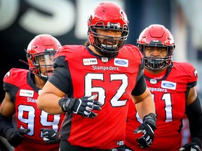 Nila Kasitati of the Calgary Stampeders runs onto the field during player introductions before facing the Winnipeg Blue Bombers in CFL football on Saturday, October 19, 2019.