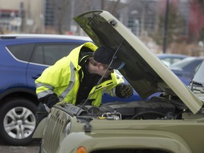 An AMA worker assists with a dead car battery.