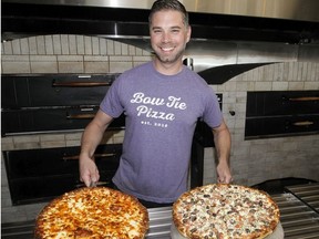 Paul Hebert, co-owner of Bow Tie Pizza poses for a photo while holding some fresh pizzas. Thursday, May 14, 2020. Brendan Miller/Postmedia