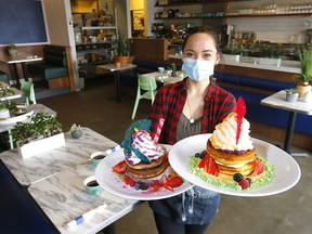 Server, Natalia Aleinati from Brekkie Cafe at 20 Westpark Link S.W. is excited to be opening up as they have changed procedures due to COVID-19 by social distancing and how they fill out the orders in Calgary on Monday, May 11, 2020.