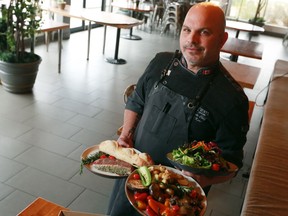 Cravings chef Daryl Kerr holds one of the Cravings gourmet barbecue kits that people can pick up and just throw on their grill for a quick meal. Kerr was photographed on Wednesday, May 6, 2020.  Gavin Young/Postmedia